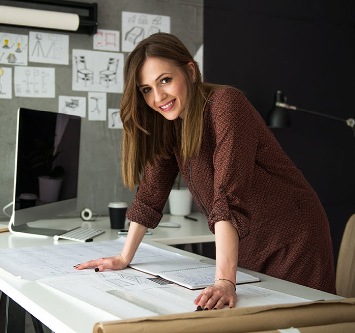 business woman leaning over her desk